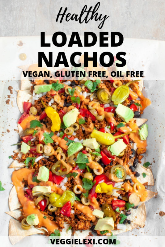 Healthy Vegan Loaded Nachos with Homemade Lime Tortilla Chips, Black Beans, Tofu Taco Crumble, Onion, Tomato, Jalapeno, Nacho Cheese Sauce, Cilantro, Avocado, and Pepperoncini. Oil Free and Gluten Free - by Veggie Lexi