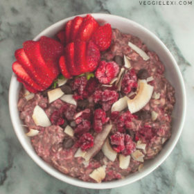 Pink Overnight Oats with Raspberries, Strawberries, Chocolate Chips, and Coconut Flakes