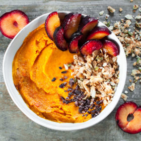 Mashed Sweet Potato with Coconut Clusters, Raw Cacao Nibs, and Sliced Plum