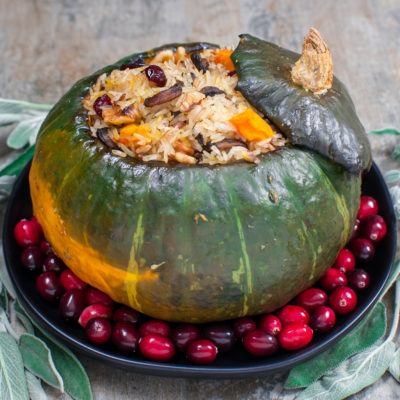 Delicious Kabocha Squash Roasted and Stuffed with Rice, Cranberries, Mushrooms, Walnuts, Onion, and Sage.