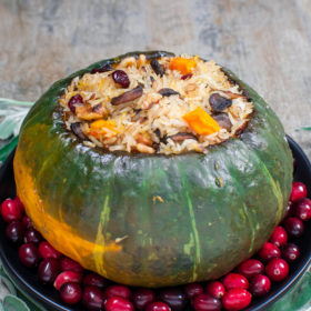 Delicious Kabocha Squash Roasted and Stuffed with Rice, Cranberries, Mushrooms, Walnuts, Onion, and Sage.