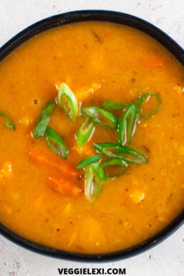 Delicious spicy sweet potato and red lentil soup! Vegan, gluten free, and made in the slow cooker. Even better, it's refined sugar free and uses the natural sweetness from frozen pineapple to balance out the heat from the chili paste. #veggielexi #slowcookerrecipes #veganrecipes #vegansoup #glutenfreerecipes - by Veggie Lexi