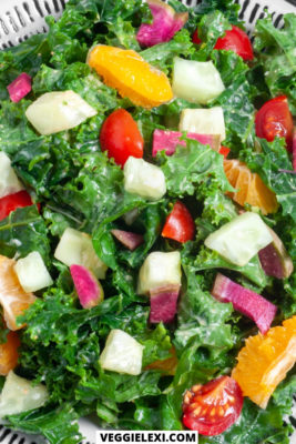 Kale salad with clementine, cucumber, watermelon radish, and cherry tomatoes. Vegan, gluten free, oil free. - by Veggie Lexi