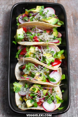 Delicious vegan, gluten free, and oil free mini taco sliders! Made with beans, fresh radish, tomato, avocado, cilantro, and sprouts. #veggielexi #veganrecipes #glutenfreerecipes #tacos