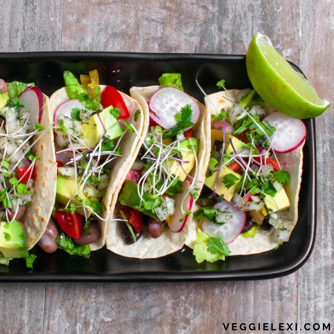Delicious vegan, gluten free, and oil free mini taco sliders! Made with beans, fresh radish, tomato, avocado, cilantro, and sprouts. #veggielexi #veganrecipes #glutenfreerecipes #tacos